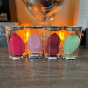 Set of 4 with containers. Assorted makeup sponges. New.